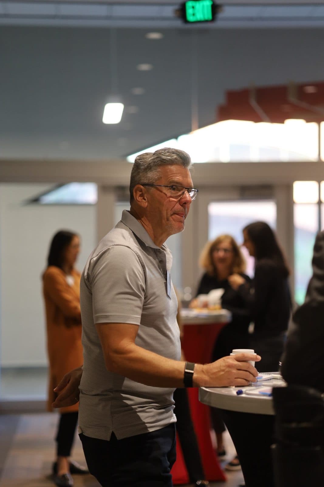 Attendees in conversation at a corporate gathering